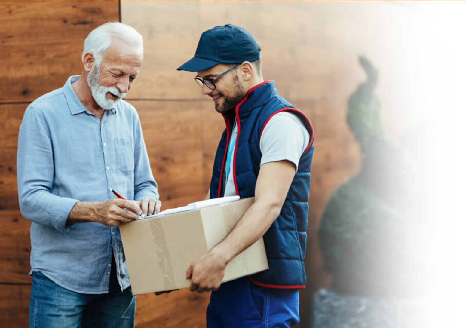 Delivery driver handing a package to a customer signing for it